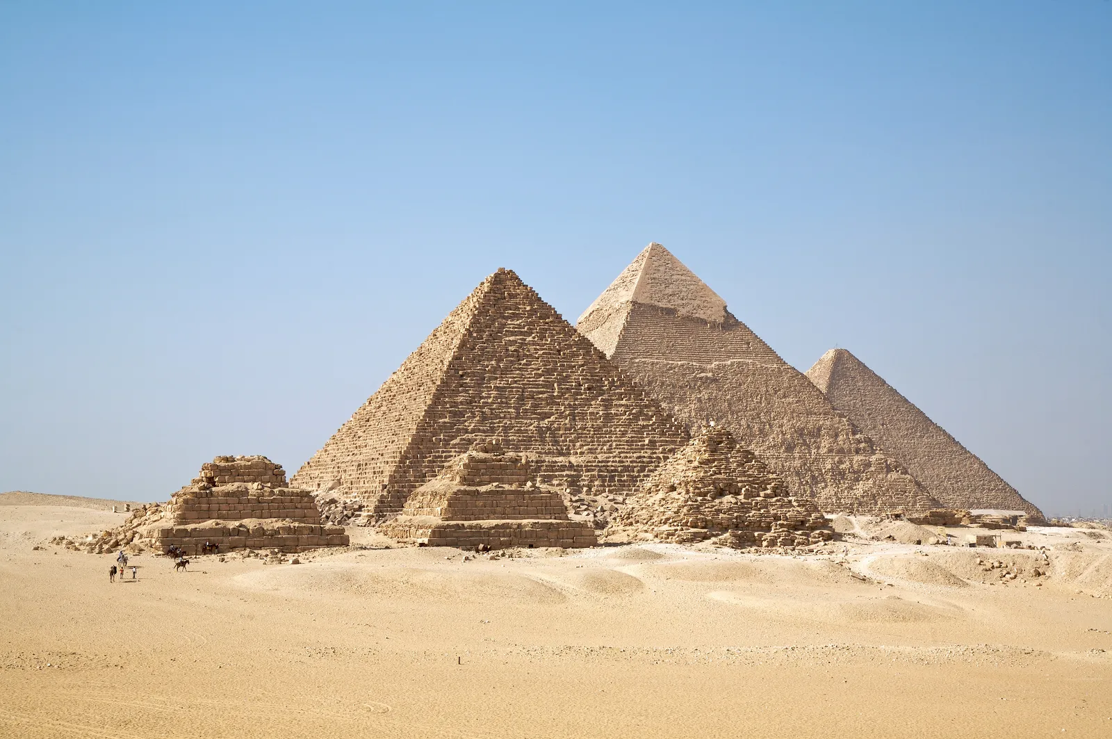 A digitally composited image showing an Air Cairo passenger jet flying dramatically close above the Great Pyramid.