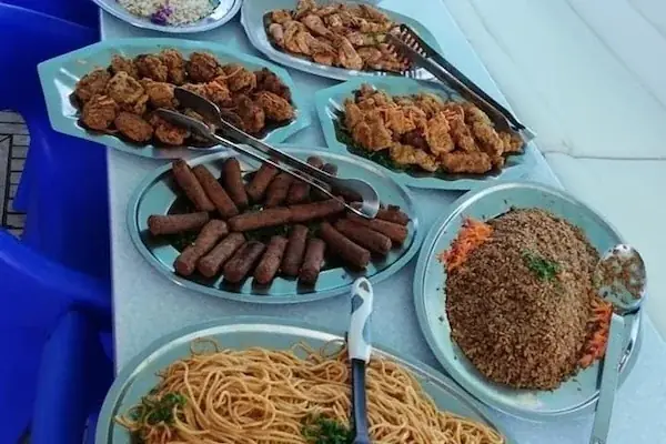 Buffet spread of seafood and Egyptian dishes including shrimp, seasoned chicken, and rice.
