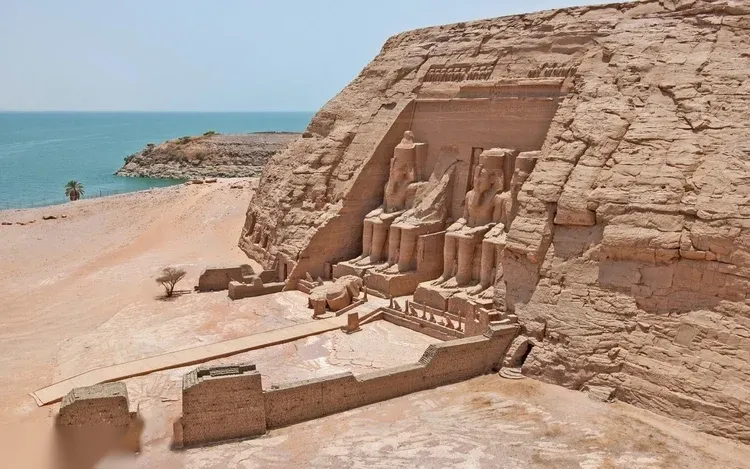 Elevated view of the Great Temple of Abu Simbel and the smaller Temple of Hathor beside it, both facing the lake.