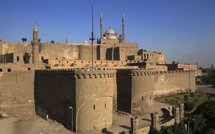 The Cairo Citadel walls with the domes and minarets of the Mohamed Ali Mosque rising behind them.