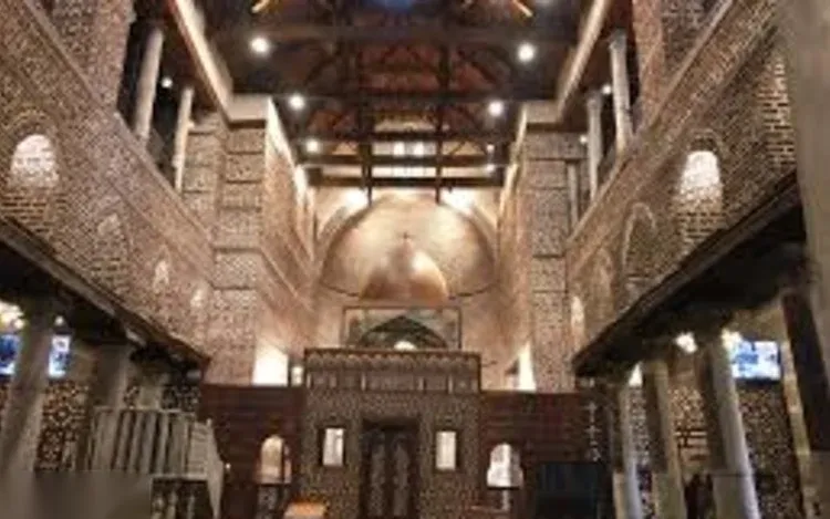 The wood-beamed interior of the Hanging Church in Coptic Cairo, with its central dome and carved pulpit.